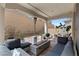 Inviting covered patio featuring a modern fire pit and comfortable seating, perfect for outdoor relaxation at 8107 Skye Sweep St, Las Vegas, NV 89166