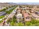 Neighborhood aerial showcasing diverse single-Gathering homes with lush landscaping against a mountain backdrop at 10085 S Riley St, Las Vegas, NV 89178