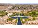 Wide aerial shot of a neighborhood with parks, playgrounds, and extensive desert landscape at 10085 S Riley St, Las Vegas, NV 89178