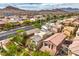 Scenic aerial view of a neighborhood featuring single-Gathering homes, lush greenery, and stunning mountain views at 10085 S Riley St, Las Vegas, NV 89178