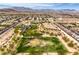 Expansive aerial view of community featuring park, playground, desert landscaping and mountains at 10085 S Riley St, Las Vegas, NV 89178