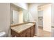 Bathroom boasts a granite-topped vanity and a large mirror at 10085 S Riley St, Las Vegas, NV 89178