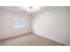 Cozy bedroom with plush carpeting and modern lighting at 10085 S Riley St, Las Vegas, NV 89178