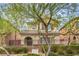 Charming two-story home with iron fence, desert landscaping, and covered entry at 10085 S Riley St, Las Vegas, NV 89178