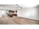 Bright, open-concept living area with wood floors, ceiling fan, and kitchen view at 10085 S Riley St, Las Vegas, NV 89178