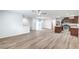 Spacious open-concept floor plan with wood floors and modern lighting fixtures at 10085 S Riley St, Las Vegas, NV 89178