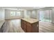 Open-concept living area with wood floors, lots of natural light, and a sliding glass door at 10085 S Riley St, Las Vegas, NV 89178