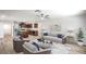 Bright, open-concept living area with wood floors, ceiling fan, and neutral color palette at 10085 S Riley St, Las Vegas, NV 89178
