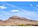 A scenic view of a large mountain range with a blue sky overhead, showcasing the natural beauty nearby at 10085 S Riley St, Las Vegas, NV 89178