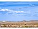 A view of mountain range with blue sky and neighborhood of single-Gathering homes in the foreground at 10085 S Riley St, Las Vegas, NV 89178
