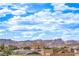 Beautiful mountain views and blue skies seen from the rooftop, overlooking a nearby neighborhood at 10085 S Riley St, Las Vegas, NV 89178
