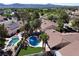 Aerial view of homes featuring private pools, well-manicured lawns, and solar panels, highlighting a luxurious residential area at 2022 Big Bend Way, Henderson, NV 89074