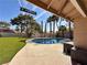 Backyard pool with stone patio and artificial turf creating a relaxing oasis at 2022 Big Bend Way, Henderson, NV 89074
