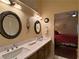 A bright bathroom features a double sink vanity, with a view of the adjacent bedroom at 2022 Big Bend Way, Henderson, NV 89074
