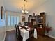 Formal dining room with seating for six, stylish chandelier, and wood floors at 2022 Big Bend Way, Henderson, NV 89074