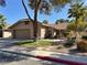 Attractive single-Gathering home with a well-manicured lawn, stone walkway, and attached two-car garage at 2022 Big Bend Way, Henderson, NV 89074