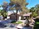 Charming single-Gathering home featuring a well-maintained front yard with mature trees at 2022 Big Bend Way, Henderson, NV 89074