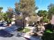 Charming single-Gathering home featuring a well-maintained front yard with mature trees and a driveway at 2022 Big Bend Way, Henderson, NV 89074