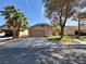 Cozy single-Gathering home with a two-car garage, green lawn, and xeriscaped landscaping for a welcoming curb appeal at 2022 Big Bend Way, Henderson, NV 89074
