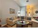 Comfortable living room with a large sectional sofa, decorative pillows, and attractive shutters at 2022 Big Bend Way, Henderson, NV 89074