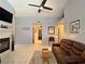 Comfortable living room with vaulted ceiling, fireplace, ceiling fan, and neutral decor at 2022 Big Bend Way, Henderson, NV 89074