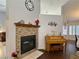 Cozy living room featuring a fireplace, piano and view into the dining room at 2022 Big Bend Way, Henderson, NV 89074