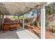 Backyard with pergola, hot tub and landscaped with desert friendly foliage at 2489 Black River Falls Dr, Henderson, NV 89044