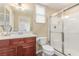 This bathroom has cherry vanity, white countertop, glass shower, and tile floors at 2489 Black River Falls Dr, Henderson, NV 89044