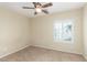 This bedroom features neutral paint, a ceiling fan and a window with shutters at 2489 Black River Falls Dr, Henderson, NV 89044
