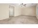 Spacious bedroom with carpet flooring, ceiling fan, and open doorway at 2489 Black River Falls Dr, Henderson, NV 89044