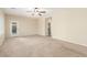 Large bedroom with carpet flooring, ceiling fan, and a door to the outside at 2489 Black River Falls Dr, Henderson, NV 89044