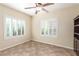 Cozy bedroom with neutral walls, tile flooring, and plantation shutters for natural light at 2489 Black River Falls Dr, Henderson, NV 89044