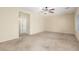 Spacious bedroom with carpet, ceiling fan, and neutral walls with bright windows at 2489 Black River Falls Dr, Henderson, NV 89044