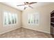Bedroom featuring tile floors, a ceiling fan, and windows with bright white shutters at 2489 Black River Falls Dr, Henderson, NV 89044