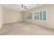 Spacious bedroom featuring carpeted floors, plantation shutters, and ample natural light at 2489 Black River Falls Dr, Henderson, NV 89044
