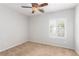 Neutral bedroom features carpeted floors, a ceiling fan, and a window at 2489 Black River Falls Dr, Henderson, NV 89044