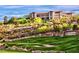 This is an amazing view of the community clubhouse atop a hill overlooking a golf course at 2489 Black River Falls Dr, Henderson, NV 89044