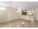 Spacious dining area with tile flooring, modern lighting fixtures, and open view to kitchen with breakfast bar at 2489 Black River Falls Dr, Henderson, NV 89044
