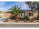 Inviting single-story home with desert landscaping, covered entry and attached two-car garage at 2489 Black River Falls Dr, Henderson, NV 89044