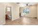 This flex room has tile floors, neutral paint, ceiling fan, window, mini fridge, and bathroom access at 2489 Black River Falls Dr, Henderson, NV 89044