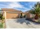 Spacious two-car garage and separate single-car garage with long driveway and mature landscaping at 2489 Black River Falls Dr, Henderson, NV 89044
