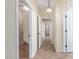 Bright hallway with tile floors and modern lighting that leads to various rooms in the house at 2489 Black River Falls Dr, Henderson, NV 89044