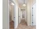 Hallway featuring tile floors, neutral paint and 3 open doorways at 2489 Black River Falls Dr, Henderson, NV 89044