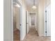 Bright hallway with tile flooring, recessed lighting, and doors leading to various rooms at 2489 Black River Falls Dr, Henderson, NV 89044
