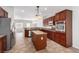 Kitchen area with dark wood cabinets, stainless steel appliances, and tile flooring at 2489 Black River Falls Dr, Henderson, NV 89044