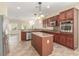 Open concept kitchen with stainless steel appliances and center island, great for entertaining at 2489 Black River Falls Dr, Henderson, NV 89044