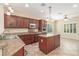 Gourmet kitchen featuring granite countertops, dark wood cabinets, and stainless steel appliances at 2489 Black River Falls Dr, Henderson, NV 89044