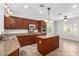 Well-lit kitchen features granite counters, stainless steel appliances and an island at 2489 Black River Falls Dr, Henderson, NV 89044