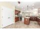 Bright kitchen with stainless steel refrigerator, center island, and pantry access at 2489 Black River Falls Dr, Henderson, NV 89044