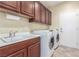 Laundry room with sink, washer and dryer, and cabinet space at 2489 Black River Falls Dr, Henderson, NV 89044